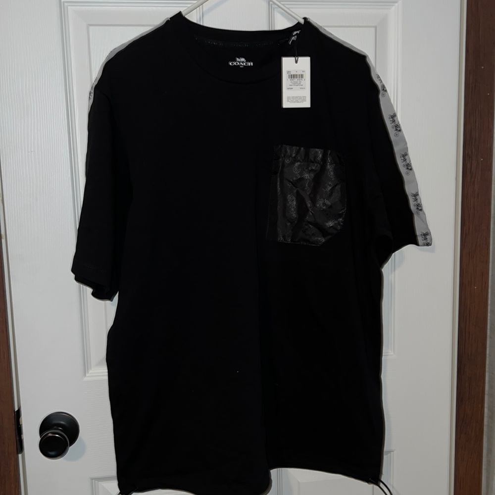 Black and white Coach men’s shirt with detailed pocket and pull strings